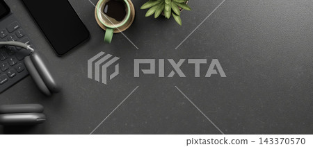 Top view of black desk with headphones over keyboard, smartphone and green coffee cup with plant pot Top view of black desk with headphones over keyboard, smartphone and green coffee cup with plant pot 143370570