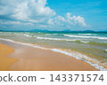 Tropical beach at Haitang Bay in Sanya Hainan with golden sand, ocean waves, and blue sky. Perfect summer vacation destination 143371574