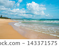 Sanya Hainan travel destination view. Sand beach, ocean waves, and cityscape on the horizon at summer day in Haitang Bay 143371575