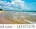 Tropical beach at Haitang Bay in Sanya Hainan with golden sand, ocean waves, and blue sky. Perfect summer vacation destination 143371576