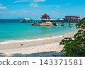 Wuzhizhou Island beach in Sanya Hainan with bridge, pagoda pavilion, turquoise ocean water, and sand coast. Tropical China travel resort 143371581