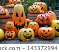 A lively Halloween decoration featuring smiling pumpkins. 143372994