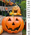 Smiling Jack-o'-lanterns and Halloween decorations 143373144