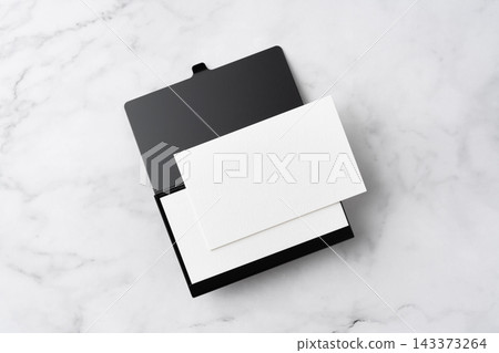 Blank white business cards and open black aluminum card holder on white marble background, top view flat lay with copy space Blank white business cards and open black aluminum card holder on white marble background, top view flat lay with copy space 143373264