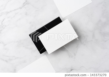 Blank white business cards and close black aluminum card holder on white marble background, top view flat lay with copy space 143373270