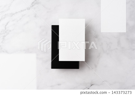 Blank white business cards and close black aluminum card holder on white marble background, top view flat lay with copy space Blank white business cards and close black aluminum card holder on white marble background, top view flat lay with copy space 143373273
