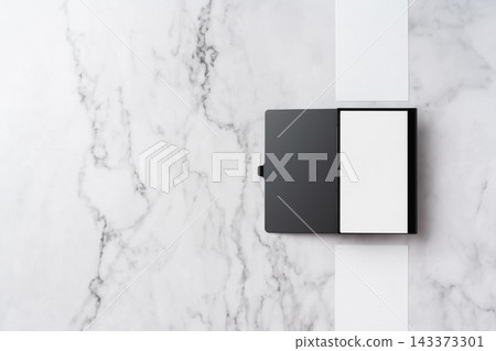 Blank white business cards and open black aluminum card holder on white marble background, top view flat lay with copy space Blank white business cards and open black aluminum card holder on white marble background, top view flat lay with copy space 143373301