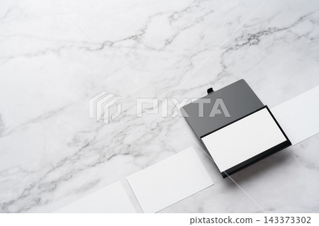 Blank white business cards and open black aluminum card holder on white marble background, high angle view with copy space Blank white business cards and open black aluminum card holder on white marble background, high angle view with copy space 143373302