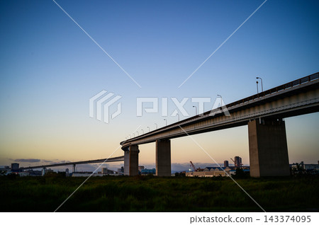 A twisted bridge stretching into the twilight sky A twisted bridge stretching into the twilight sky 143374095