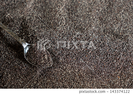 Spoon filled with ground poppy seeds on textured background with copy space Spoon filled with ground poppy seeds on textured background with copy space 143374122