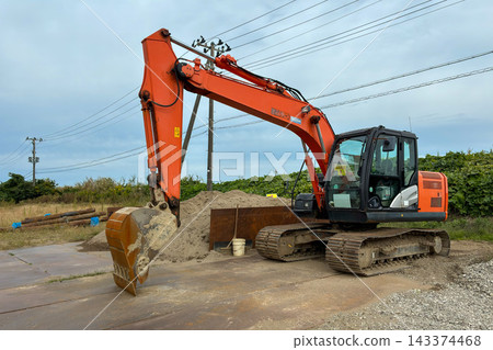 A large power shovel parked at a materials storage area. 143374468