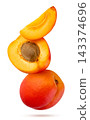 Ripe apricot and two halves flying close-up on a white background. Isolated 143374696