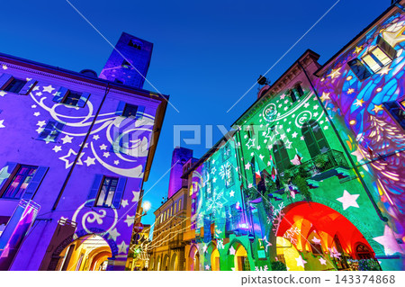 Historic buildings of Alba, Italy, illuminated by colorful light projections during Christmas Historic buildings of Alba, Italy, illuminated by colorful light projections during Christmas 143374868