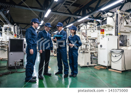 A group of factory workers. Manufacturing, industry, teamwork, machinery, production, processing, engineers, instruction, training. A group of factory workers. Manufacturing, industry, teamwork, machinery, production, processing, engineers, instruction, training. 143375000