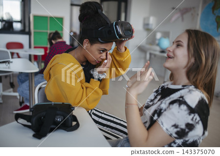 High school student using virtual reality for immersive learning in classroom. High school student using virtual reality for immersive learning in classroom. 143375070