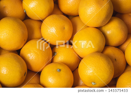 Heap of fresh ripe oranges in the grocery store shelf or local market Heap of fresh ripe oranges in the grocery store shelf or local market 143375433