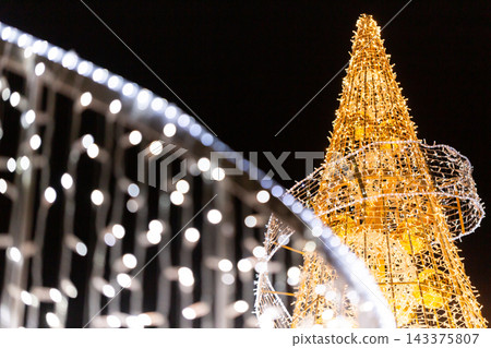 Gold and white illuminations sparkle in the nighttime light sculptures, illuminated outdoor lights Gold and white illuminations sparkle in the nighttime light sculptures, illuminated outdoor lights 143375807