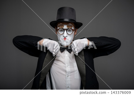 Male mime artist performing classic invisible wall illusion Male mime artist performing classic invisible wall illusion 143376009