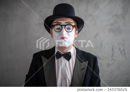 Close up portrait of a sad male mime wearing double glasses Close up portrait of a sad male mime wearing double glasses 143376029