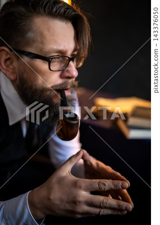 Portrait of a man smoking a traditional pipe Portrait of a man smoking a traditional pipe 143376050