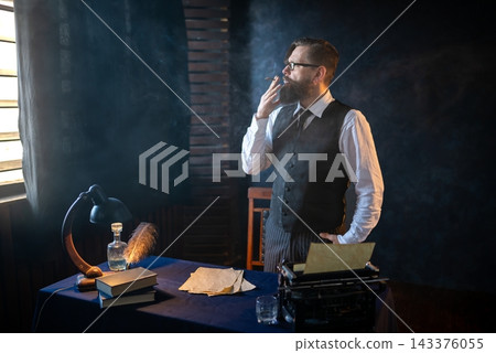 Thoughtful writer smoking a cigar near his workspace Thoughtful writer smoking a cigar near his workspace 143376055