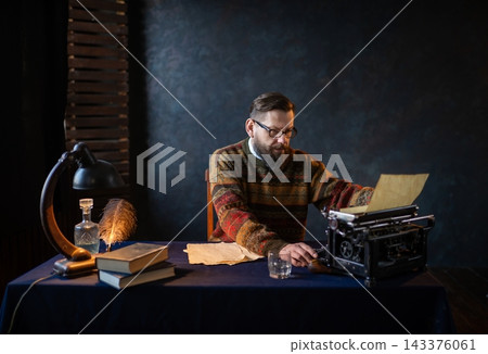 Writer looking down at a vintage typewriter machine Writer looking down at a vintage typewriter machine 143376061