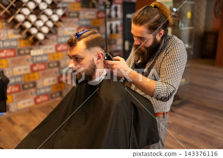 Side view of precise hair fading process in studio Side view of precise hair fading process in studio 143376116