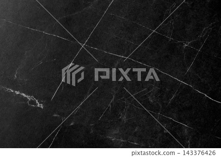 Textured background with a pattern made of black marble. 143376426