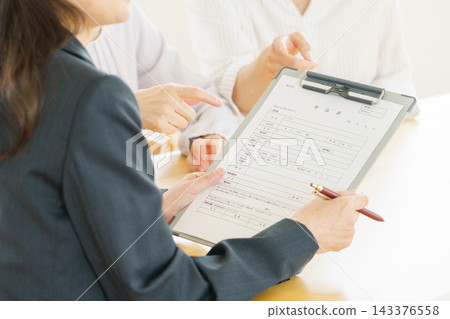 日本女性雙手拿著申請表的特寫鏡頭。 143376558