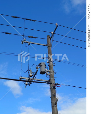 Pole-mounted transformer attached to a utility pole Pole-mounted transformer attached to a utility pole 143376569