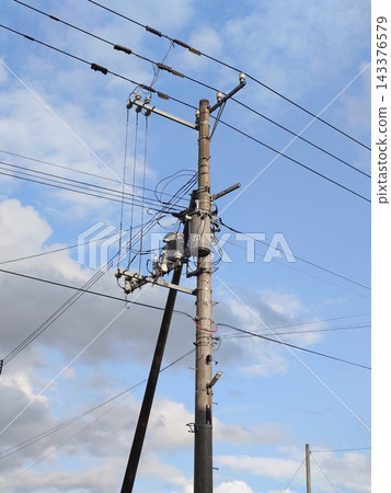 Pole-mounted transformer attached to a utility pole Pole-mounted transformer attached to a utility pole 143376579