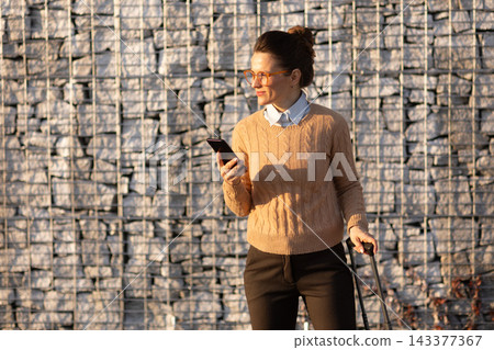 Contented Woman Waiting for Train with Luggage Contented Woman Waiting for Train with Luggage 143377367