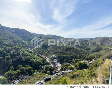Green hills and villas in valley near Granadella with cars on road, Javea Green hills and villas in valley near Granadella with cars on road, Javea 143378724