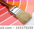 Paintbrush on Pink and Orange Color Swatches for Home Interior Painting and Design Palette Selection 143379289