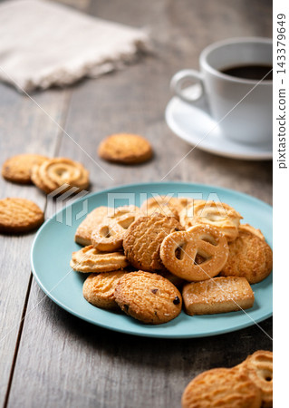 Assorted butter cookies on plate with cup of coffee 143379649