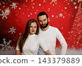 Confident couple posing on festive Christmas background 143379889