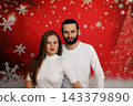 Confident couple posing on festive Christmas background 143379890