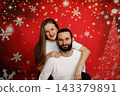 Happy couple posing together on Christmas background 143379891