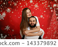 Happy couple hugging on festive Christmas background 143379892