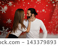 Romantic couple touching faces on Christmas background 143379893
