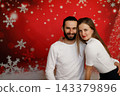 Happy couple posing together on Christmas background 143379896