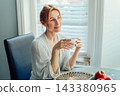 Relaxed Middle aged no make up woman enjoying cup of hot morning coffee or tea drink sitting at home kitchen. Happy calm female taking break for mental health wellbeing. right way to start new day 143380965