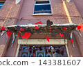 A garland above the entrance made of red and chocolate hearts. Concept March 8, Valentine s Day, Family Day. 143381607