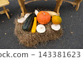 Pumpkins, zucchinis, and pattypan squash laid out on a bed of hay. The concept of a harvest festival in honor of Thanksgiving and Halloween. 143381623