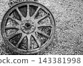 Black and white high angle shot of an old rustic wooden wagon wheel 143381998