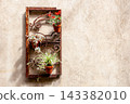 Vintage rusty iron grate planter holder hanging on a textured wall 143382010