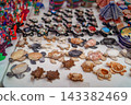 Assorted carved stone turtle figurines arranged on white market table 143382469