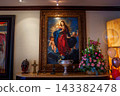 Classical religious painting in ornate gold frame above mantel 143382478