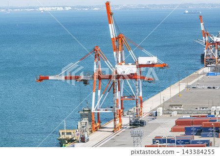 Container ship and gantry crane docked in port Container ship and gantry crane docked in port 143384255