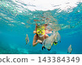 Happy family - active woman in snorkeling mask dive underwater, see tropical fishes in coral reef sea pool. Travel adventure, swimming activity and watersports on summer beach vacation with child. 143384349